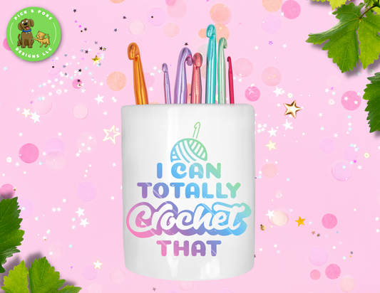 White ceramic pencil holder with the phrase "I can totally crochet that" written in a colorful font.