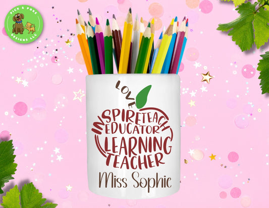 Personalized teacher apple word art ceramic pen and pencil holder displayed with set of colored pencils