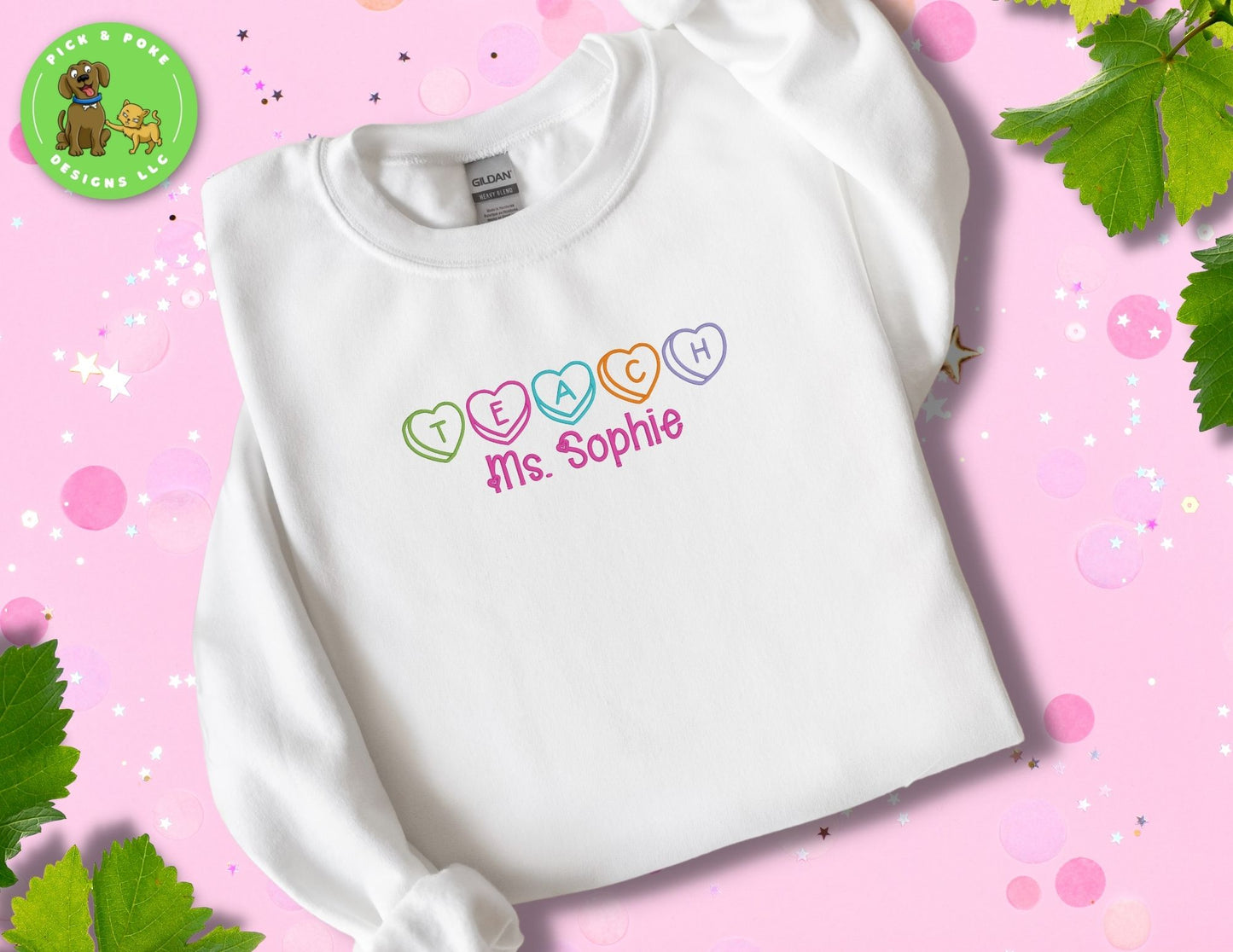 White Gildan brand crewneck style sweatshirt embroidered with the Word teach and the teacher's name written with hearts. 
