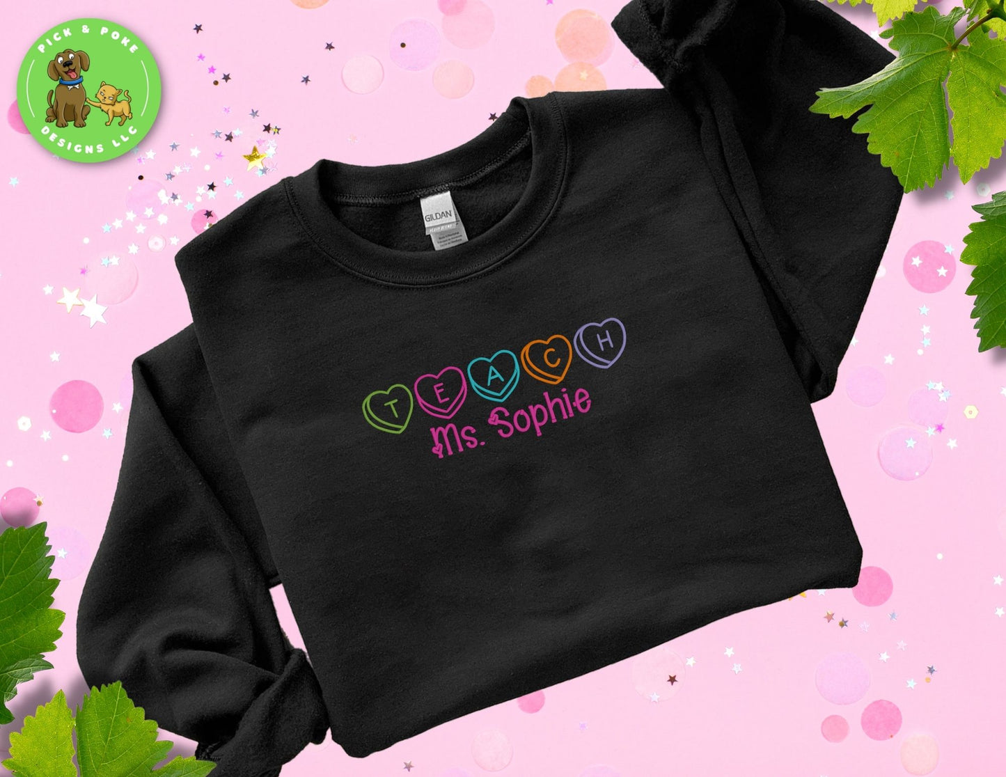 Black Gildan brand crewneck style sweatshirt embroidered with the Word teach and the teacher's name written with hearts. 